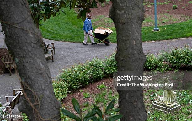 Volunteer Thomas Tazanu carts palm crosses to adorn the Stations of the Cross in the grotto at the Franciscan Monastery of The Holy Land in...