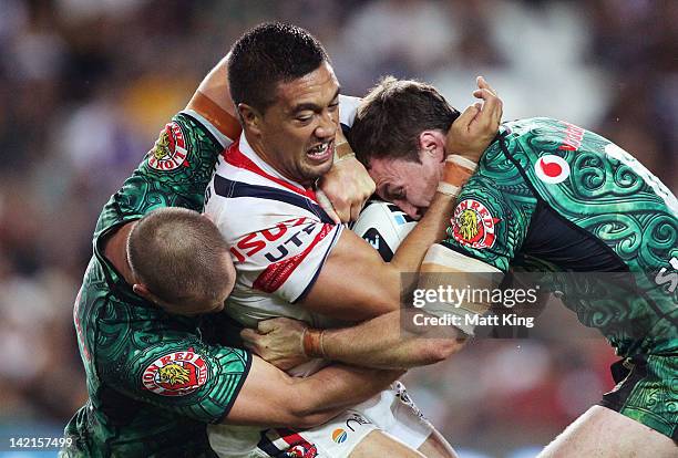 Tinirau Arona of the Roosters is tackled during the round five NRL match between the Sydney Roosters and the New Zealand Warriors at Allianz Stadium...