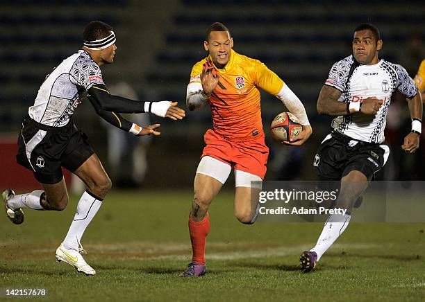 Dan Norton of England evades the Fiji defence during the match between England and Fiji during day one of the Tokyo Sevens at Prince Chichibu Stadium...