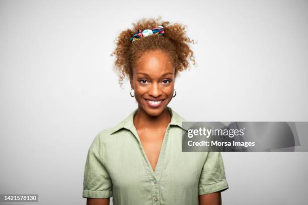 close-up portrait of young confident african american businesswoman is against white background. - hair back stock pictures, royalty-free photos & images