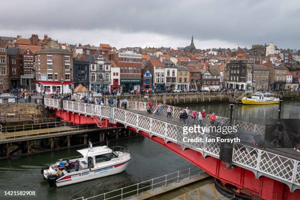 Private fishing charter sails out under Whitby swing bridge on September 07, 2022 in Whitby, England. Whitby is a seaside town in Yorkshire, northern...