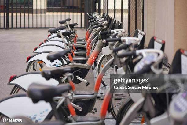 lot of electric bicycles on street - electric motorsport stock pictures, royalty-free photos & images