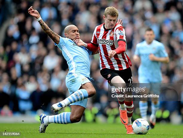 James McClean of Sunderland is tackled by Nigel de Jong of Manchester City during the Barclays Premier League match between Manchester City and...