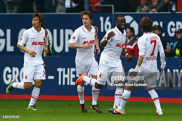 Nando Rafael of Augsburg celebrates his team's second goal with team mates Ja-Cheol Koo, Paul Verhaegh and Hajime Hosogai during the Bundesliga match...