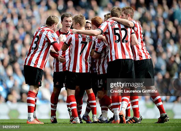 Sebastian Larsson of Sunderland is mobbed by his team mates after scoring the opening goal during the Barclays Premier League match between...