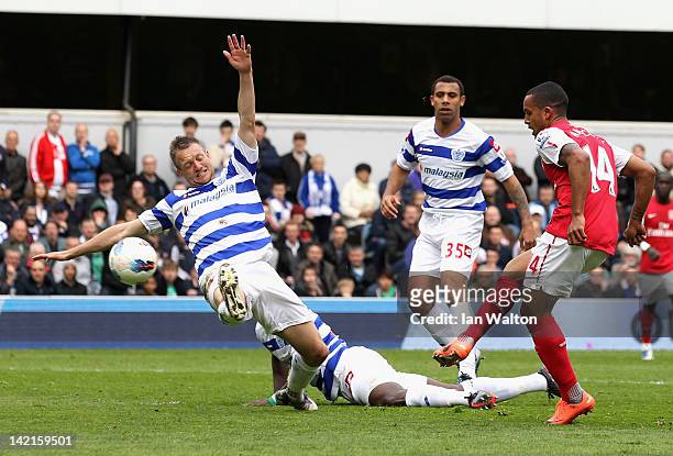 Theo Walcott of Arsenal scores his side's equalising goal during the Barclays Premier League match between Queens Park Rangers and Arsenal at Loftus...