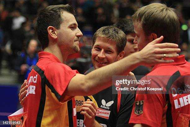 Timo Boll, Bastian Steger and Patrick Baum of Germany celebrate the victory after the LIEBHERR table tennis team world cup 2012 championship division...