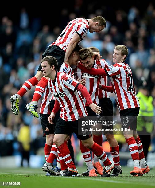 Nicklas Bendtner of Sunderland celebrates with his team mates after scoring his team's second goal during the Barclays Premier League match between...
