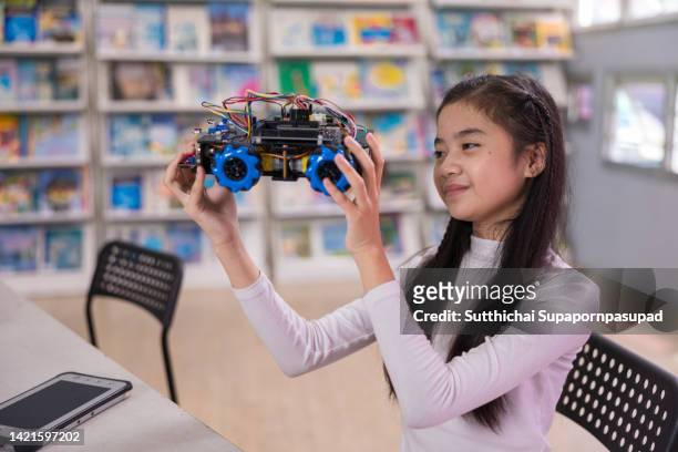 asian girl working robotic car model in the classroom. education and innovation concept. - students plant lab stock pictures, royalty-free photos & images