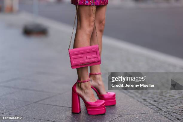 Palina Kozyrava is seen wearing pink flower pattern short skirt, pink leather Fendi bag and pink plateau Versace heels, during Berlin Fashion Week...