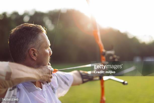 outdoors archery training - archery bow stock pictures, royalty-free photos & images