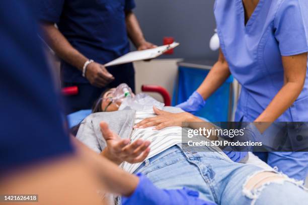 female patient reaching out - triage stock pictures, royalty-free photos & images