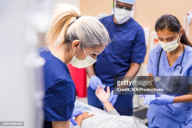 doctors talking to the patient - emergency medicine stock pictures, royalty-free photos & images