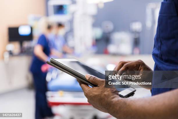unrecognizeable person using digital tablet - doctors equipment stockfoto's en -beelden