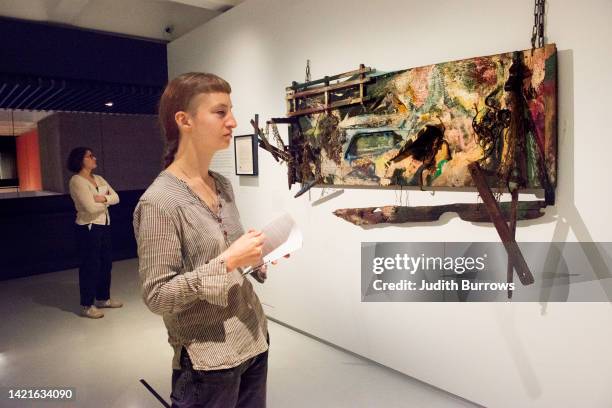 Visitors viewing one of the artworks featured in 'Body Politics', a retrospective of the work of American visual experimental artist, Carolee...