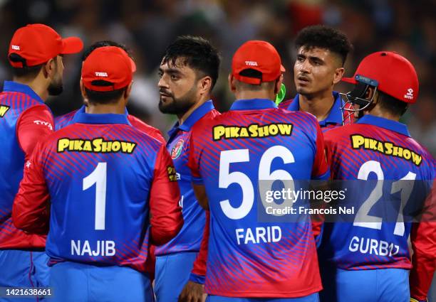 Rashid Khan of Afghanistan speaks to his team mates during the DP World Asia Cup match between Afghanistan and Pakistan at Sharjah Cricket Stadium on...