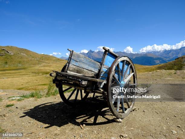 old wooden wagon in the mountains - early american western art stock pictures, royalty-free photos & images