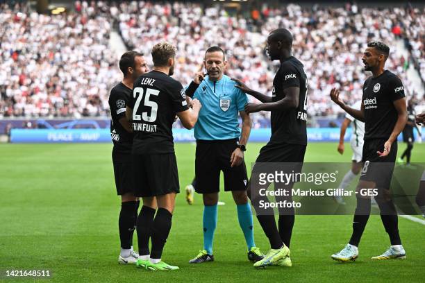 Referee Orel Grinfeeld awaits a video assistant decision while Mario Goetze, Christopher Lenz and Evan N'Dicka talking to him during the UEFA...