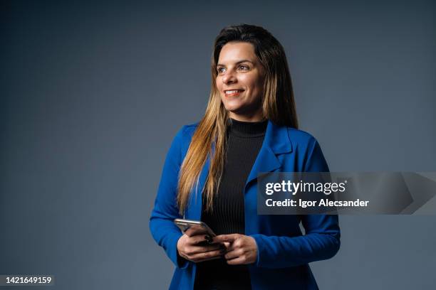 portrait of a businesswoman looking to the future (concept) - business woman blue stock pictures, royalty-free photos & images