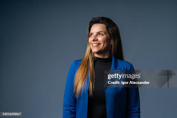 portrait of a businesswoman looking to the future (concept) - blue background portrait bildbanksfoton och bilder