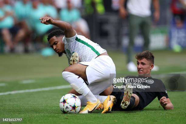 Marcus Edwards of Sporting CP is tackled by Jesper Lindstrom of Eintracht Frankfurt during the UEFA Champions League group D match between Eintracht...