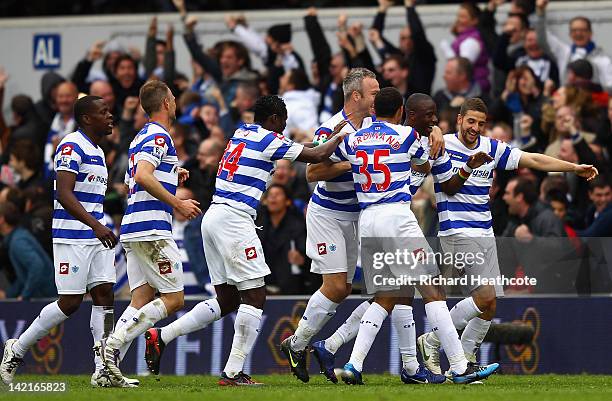 Samba Diakite of Queens Park Rangers celebrates scoring his side's second goal with team mates during the Barclays Premier League match between...