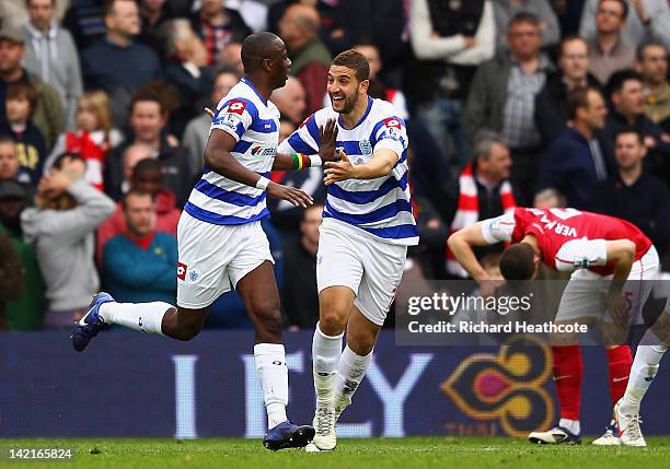 Samba Diakite of Queens Park Rangers celebrates scoring his side's second goal with team mate Adel Taarabt during the Barclays Premier League match...