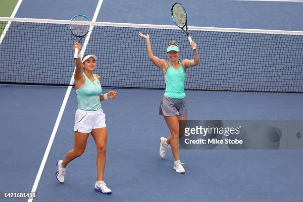 Caroline Dolehide of the United States and Storm Sanders of Australia celebrate after defeating Caroline Garcia of France and Kristina Mladenovic of...