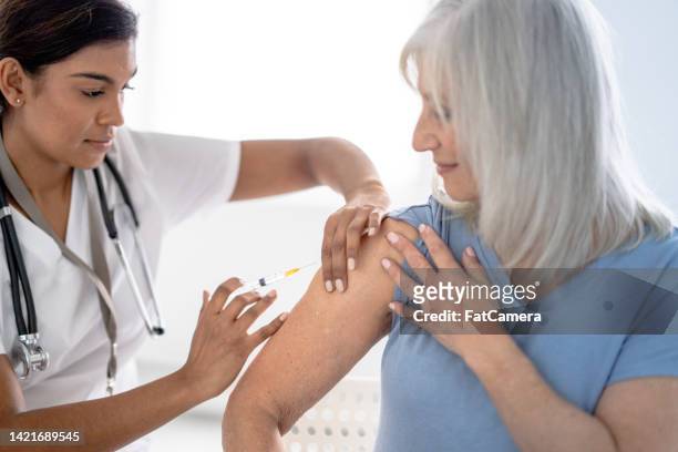 vaccine for a senior - shot stock pictures, royalty-free photos & images