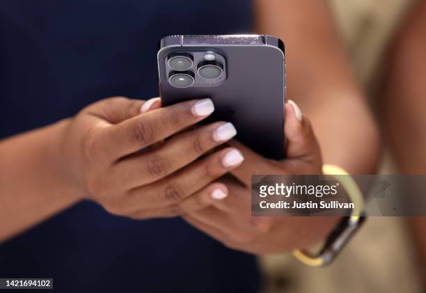 An attendee holds a new Apple iPhone 14 Pro during an Apple special event on September 07, 2022 in Cupertino, California. Apple unveiled the new...