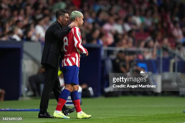 Diego Simeone, Head Coach of Atletico de Madrid talks with Antoine Griezmann of Atletico de Madrid who prepares to be substituted on during the UEFA...