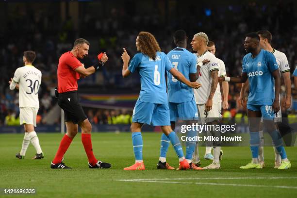 Matteo Guendouzi of Marseille reacts to match referee Slavko Vincic who shows a red card to Chancel Mbemba of Marseille during the UEFA Champions...