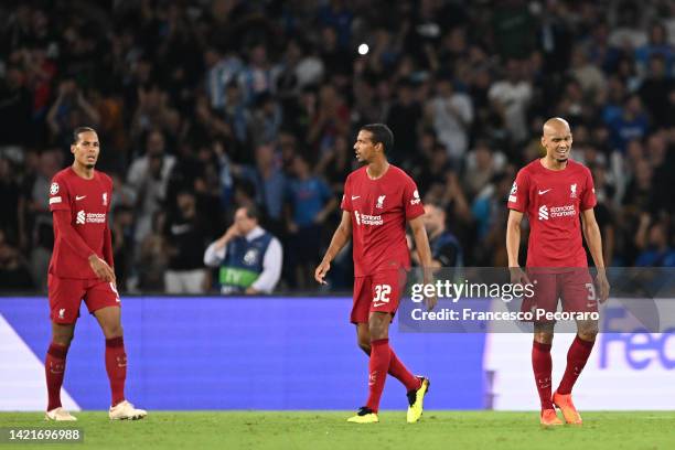 Virgil van Dijk, Joel Matip and Fabinho of Liverpool look dejected after Piotr Zielinski of SSC Napoli scores their team's fourth goal during the...