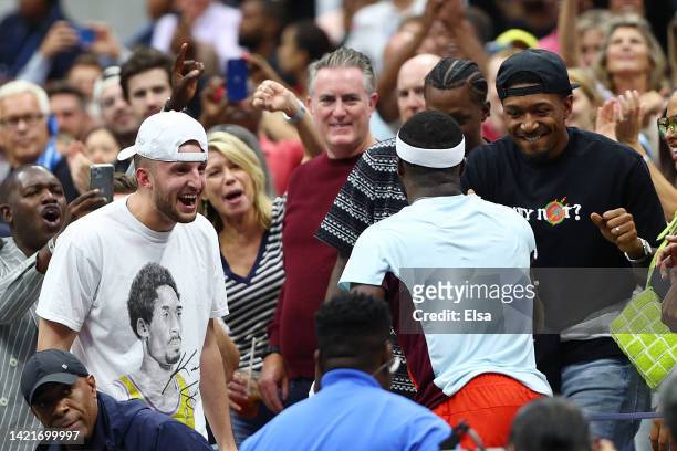 Frances Tiafoe of the United States celebrates with Bradley Beal after defeating Andrey Rublev during their Men’s Singles Quarterfinal match on Day...