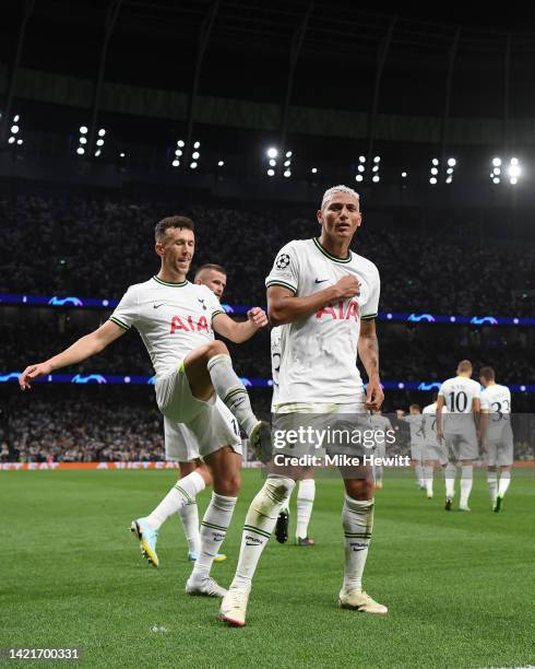 Richarlison of Tottenham Hotspur is congratulated by teammate Ivan Perisic after scoring their team's first goal during the UEFA Champions League...