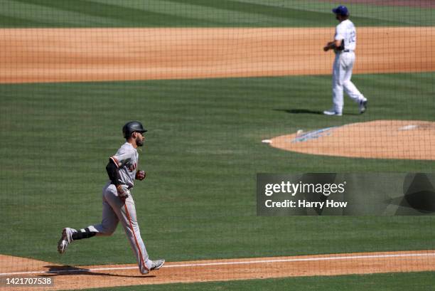 David Villar of the San Francisco Giants runs the bases around Clayton Kershaw of the Los Angeles Dodgers after his two run homerun, to take a 2-0...