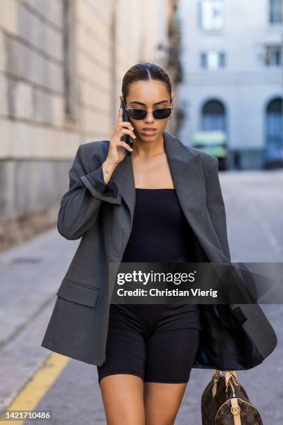 Berta Ribot wearing grey oversized blazer, Louis Vuitton bag, shorts, laced Louis Vuitton boots on September 07, 2022 in Barcelona, Spain.