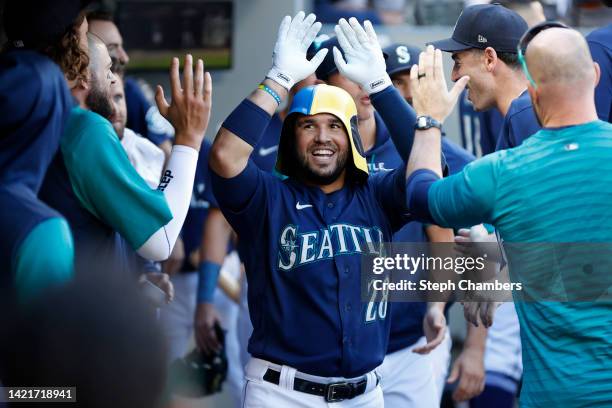 Eugenio Suarez of the Seattle Mariners celebrates his home run in the dugout during the seventh inning against the Chicago White Sox at T-Mobile Park...