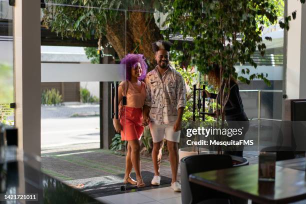 afro couple entering the restaurant - curly purple hair stock pictures, royalty-free photos & images