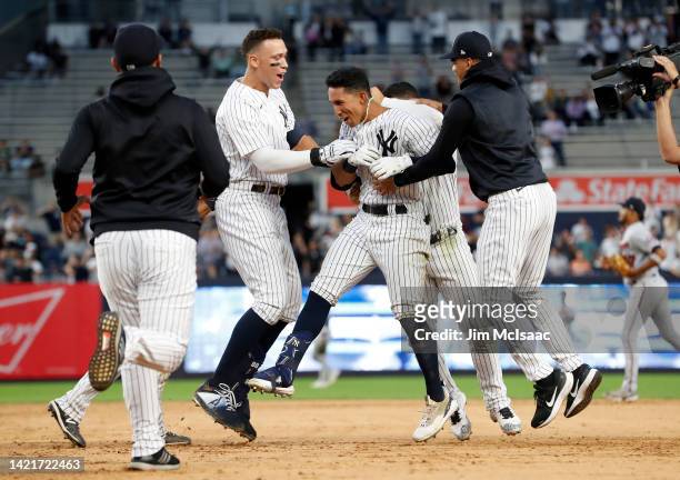Oswaldo Cabrera of the New York Yankees celebrates his twelfth inning game-winning base hit with teammates in game one of a doubleheader against the...