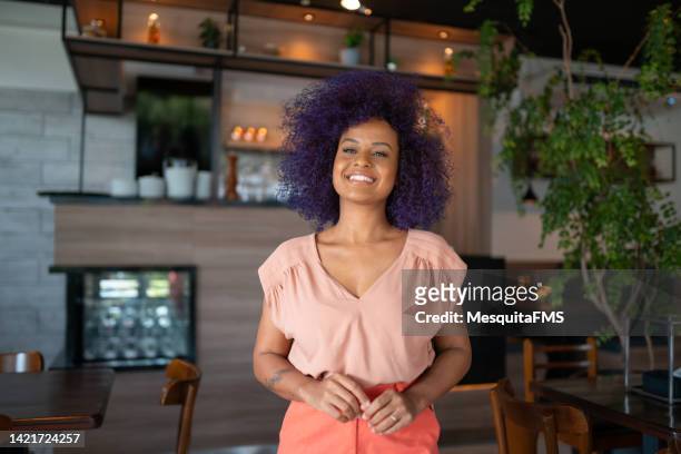 portrait of afro woman in the restaurant - purple hair stock pictures, royalty-free photos & images