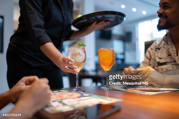 waitress serving alcoholic beverage - service anniversary stock pictures, royalty-free photos & images