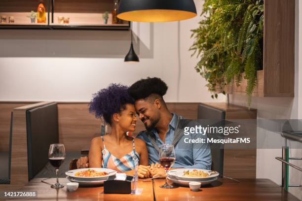 loving couple in restaurant - young couple date night wine stock pictures, royalty-free photos & images