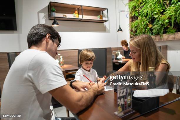 family in the restaurant - kid waiting stock pictures, royalty-free photos & images