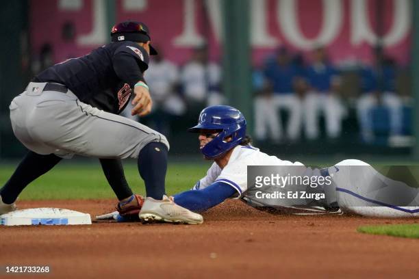 Bobby Witt Jr. #7 of the Kansas City Royals is tagged out at second by Andres Gimenez of the Cleveland Guardians as he tries to steal second in the...