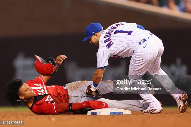 Nick Madrigal of the Chicago Cubs tags out Jose Barrero of the Cincinnati Reds attempting to steal second base during the third inning at Wrigley...