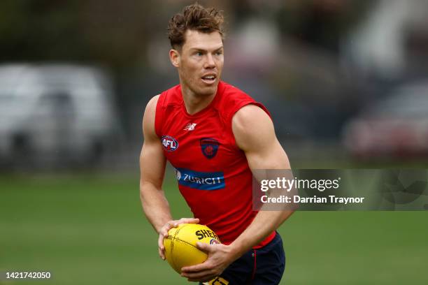 Jake Melksham of the Demons runs with the ball during a Melbourne Demons AFL training session at Gosch's Paddock on September 08, 2022 in Melbourne,...