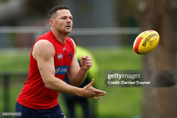 Steven May of the Demons handballs during a Melbourne Demons AFL training session at Gosch's Paddock on September 08, 2022 in Melbourne, Australia.