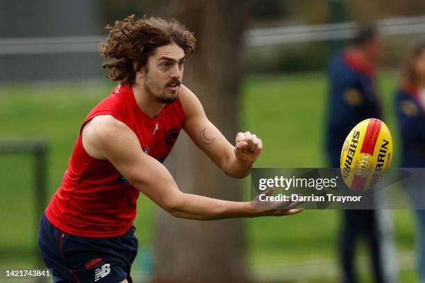 Luke Jackson of the Demons handballs during a Melbourne Demons AFL training session at Gosch's Paddock on September 08, 2022 in Melbourne, Australia.