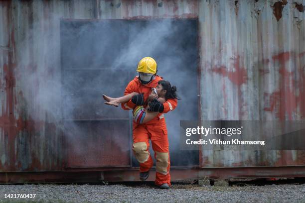 firefighter professionally rescue the victim on emergency - accidents and disasters photos fotografías e imágenes de stock